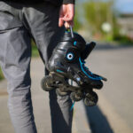 Male person hands with roller skates