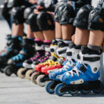 Feet of rollerbladers wearing inline roller skates sitting in outdoor skate park, Close up view of wheels befor city race for healthy and active life